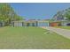 Charming one-story home featuring a well-manicured lawn and a spacious two-car garage at 6211 Se 126Th St, Belleview, FL 34420