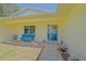 Welcoming front porch featuring seating and colorful flower arrangements at 6211 Se 126Th St, Belleview, FL 34420