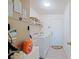 Well-equipped laundry room includes a washer, dryer, shelving, storage, and a utility sink at 6211 Se 126Th St, Belleview, FL 34420