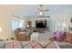 Open-concept living room with ample seating, natural light, and a ceiling fan at 6211 Se 126Th St, Belleview, FL 34420