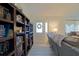 Inviting living room with bookshelf, comfortable seating, and a bright window at 6211 Se 126Th St, Belleview, FL 34420
