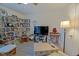 Inviting living room with wood-look floors, bookshelves, comfy furniture, and a large TV at 6211 Se 126Th St, Belleview, FL 34420
