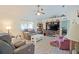 Cozy living room featuring comfortable sofas, a ceiling fan, and entertainment center at 6211 Se 126Th St, Belleview, FL 34420