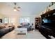 Comfortable living room featuring a ceiling fan, plush seating, and a large TV at 6211 Se 126Th St, Belleview, FL 34420