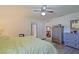 Spacious main bedroom with a ceiling fan, natural light, and closet access at 6211 Se 126Th St, Belleview, FL 34420