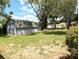 Spacious backyard featuring a storage shed and mature trees offering ample shade at 70 Almond Pass Dr, Ocala, FL 34472