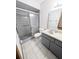 Bathroom featuring a walk-in shower with glass door and gray vanity at 70 Almond Pass Dr, Ocala, FL 34472