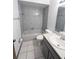 Bathroom features gray tile and vanity at 70 Almond Pass Dr, Ocala, FL 34472