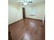 Bright bedroom featuring a ceiling fan and wood laminate flooring at 70 Almond Pass Dr, Ocala, FL 34472