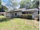 Charming home with mature landscaping and a well-maintained lawn at 70 Almond Pass Dr, Ocala, FL 34472