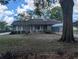 Charming single-story home with a cozy front porch, well-maintained landscaping, and covered carport at 70 Almond Pass Dr, Ocala, FL 34472