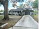 Well-kept single-story house featuring a cozy front porch, well-kept yard, and convenient carport at 70 Almond Pass Dr, Ocala, FL 34472