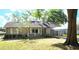 Charming single-story home with a well-maintained lawn, covered carport and gray siding at 70 Almond Pass Dr, Ocala, FL 34472