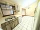 Kitchen with tile floors, plenty of cabinet space, modern appliances and window over the sink at 70 Almond Pass Dr, Ocala, FL 34472