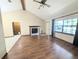 Well-lit living room showcasing hardwood floors, fireplace and large window with natural light at 70 Almond Pass Dr, Ocala, FL 34472