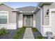 A close up on the front entrance shows a well maintained walkway and door at 7270 Sw 99Th Cir, Ocala, FL 34481