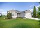 Beautifully landscaped front yard with a one-story home, complemented by a well-kept lawn at 7270 Sw 99Th Cir, Ocala, FL 34481