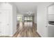 A bright and airy home interior with hard floors with view of living spaces and kitchen at 7270 Sw 99Th Cir, Ocala, FL 34481