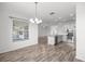 Open-concept kitchen showcases stainless steel appliances, granite countertops, white cabinetry and wood flooring at 7270 Sw 99Th Cir, Ocala, FL 34481