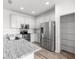 Bright kitchen features stainless steel appliances, granite countertops, white cabinetry and a walk-in pantry at 7270 Sw 99Th Cir, Ocala, FL 34481