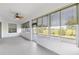 Bright tiled lanai with large windows offers views of lush backyard and landscaping at 7270 Sw 99Th Cir, Ocala, FL 34481