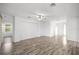 Spacious living room with modern ceiling fan and wood flooring at 7270 Sw 99Th Cir, Ocala, FL 34481
