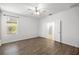 Main bedroom with wood flooring, a ceiling fan, and ensuite bathroom at 7270 Sw 99Th Cir, Ocala, FL 34481