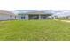 Home showcasing a large, green backyard, covered patio, and lush lawn at 7536 Sw 60Th St, Ocala, FL 34476