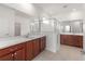 Bathroom with dual vanities, granite counters, a glass shower, and tile floors at 7536 Sw 60Th St, Ocala, FL 34476