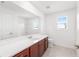 Bright bathroom featuring a white quartz vanity, tiled floor, and a large mirror at 7536 Sw 60Th St, Ocala, FL 34476