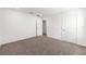 Neutral carpeting bedroom showing the closet and bathroom doors at 7536 Sw 60Th St, Ocala, FL 34476