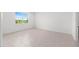 Bright bedroom with a window offering a scenic view and tiled flooring at 7536 Sw 60Th St, Ocala, FL 34476
