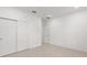 Open bedroom with closet doors, tiled flooring, and neutral paint at 7536 Sw 60Th St, Ocala, FL 34476