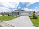 Charming two-story home featuring a well-manicured lawn and a two-car garage with stylish curb appeal at 7536 Sw 60Th St, Ocala, FL 34476