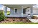 Inviting front porch with decorative landscaping and neutral tones adding to the home's curb appeal at 7536 Sw 60Th St, Ocala, FL 34476