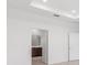 Bright hallway leading to the bathroom with recessed lights and white doors at 7536 Sw 60Th St, Ocala, FL 34476