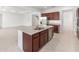 Modern kitchen with stainless appliances, granite countertops, large island with seating, and dark wood cabinetry at 7536 Sw 60Th St, Ocala, FL 34476