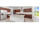 Bright kitchen featuring dark cabinets, granite countertops, a large island, and stainless steel appliances at 7536 Sw 60Th St, Ocala, FL 34476