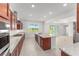 Well-lit kitchen featuring a large island, granite countertops, and stainless steel appliances at 7536 Sw 60Th St, Ocala, FL 34476