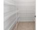 Spacious walk-in pantry featuring wire shelving and tiled floor at 7536 Sw 60Th St, Ocala, FL 34476