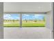 Covered patio overlooking green backyard with a view of the community and blue skies at 7536 Sw 60Th St, Ocala, FL 34476