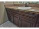 Close up of bathroom vanity with dark wood cabinetry and granite countertop at 8040 Sw 131St Ln, Ocala, FL 34473