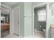 Bathroom doorway and view of toilet room and bedroom at 8352 Se 168Th Trinity Pl, The Villages, FL 32162