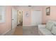 Bedroom featuring a sofa, wall art, and doorways to the hallway and closet at 8352 Se 168Th Trinity Pl, The Villages, FL 32162