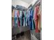 Walk-in closet with colorful clothing and shelving at 8352 Se 168Th Trinity Pl, The Villages, FL 32162