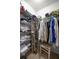 Walk-in closet with wire shelving and a variety of clothing and accessories at 8352 Se 168Th Trinity Pl, The Villages, FL 32162