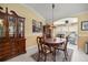Elegant dining area with a classic hutch, ornate lighting, and comfortable seating at 8352 Se 168Th Trinity Pl, The Villages, FL 32162
