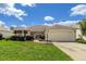 Charming single-story home with well-maintained landscaping and a two-car garage at 8352 Se 168Th Trinity Pl, The Villages, FL 32162