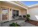 Inviting front porch area with seating and a 'Blessed' welcome mat at 8352 Se 168Th Trinity Pl, The Villages, FL 32162