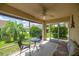Screened lanai with ceiling fan offers a relaxing outdoor space to enjoy the views of the home's landscaping at 8352 Se 168Th Trinity Pl, The Villages, FL 32162